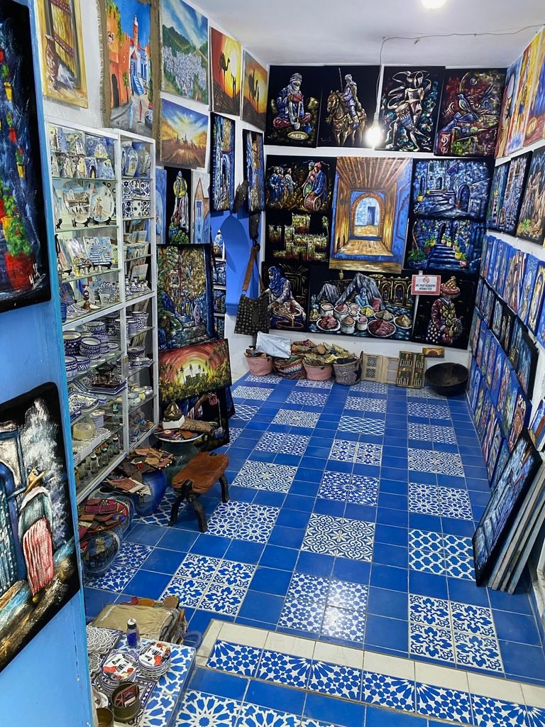 inside a shop with lots of pictures for sale