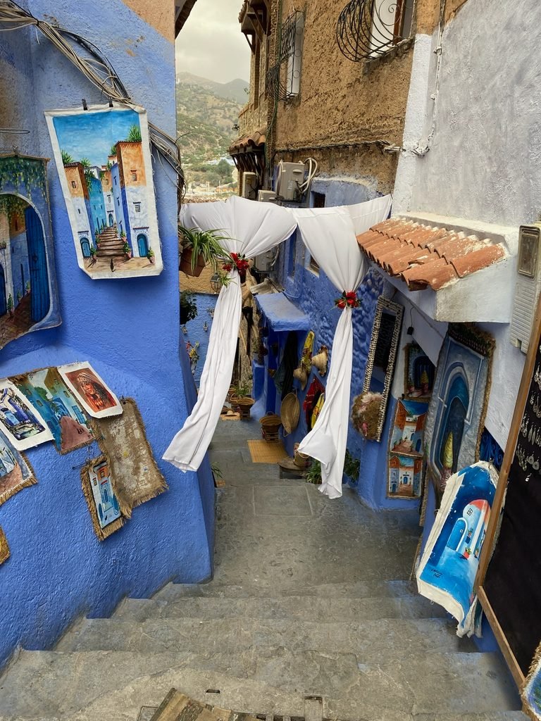 blue street with white clothes blowing in the breeze