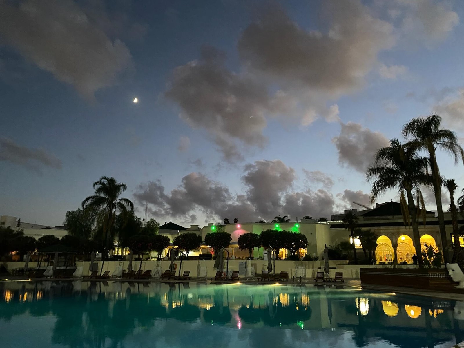 hotel pool lit up at night