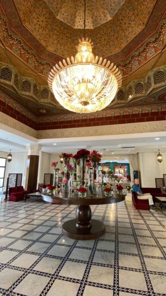 hotel reception with big light and table of flowers