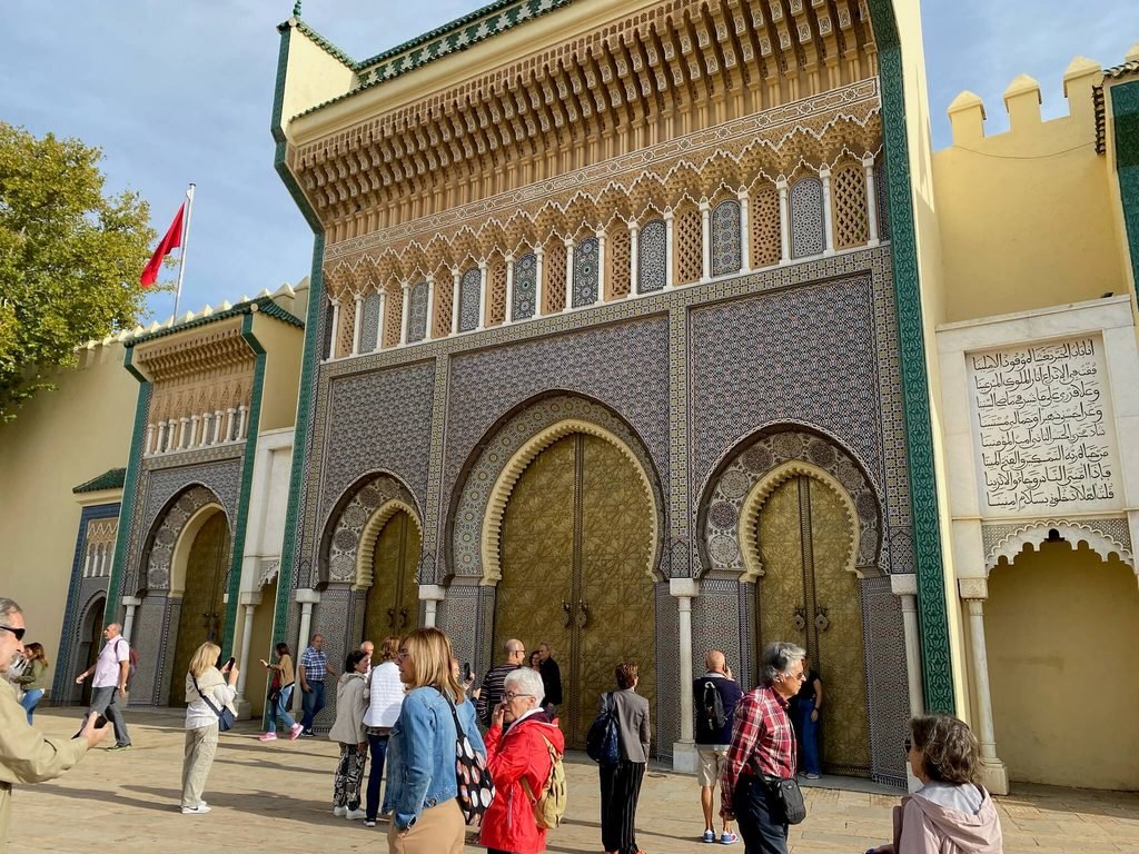 royal palace gates and people admiring