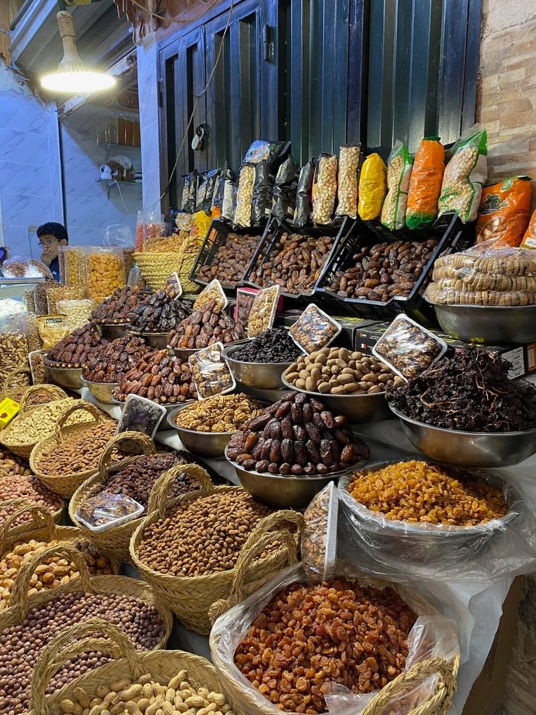 medina street with loads of buckets of nuts and spices