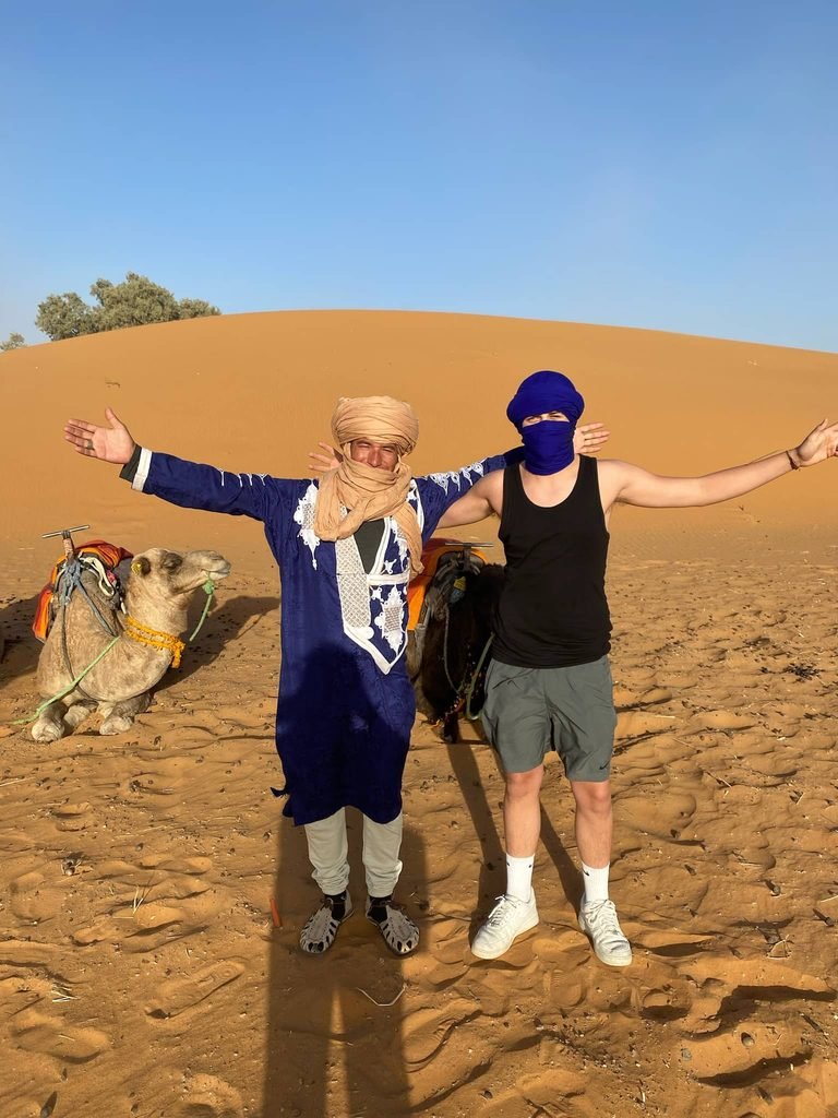 son and guide next to camels