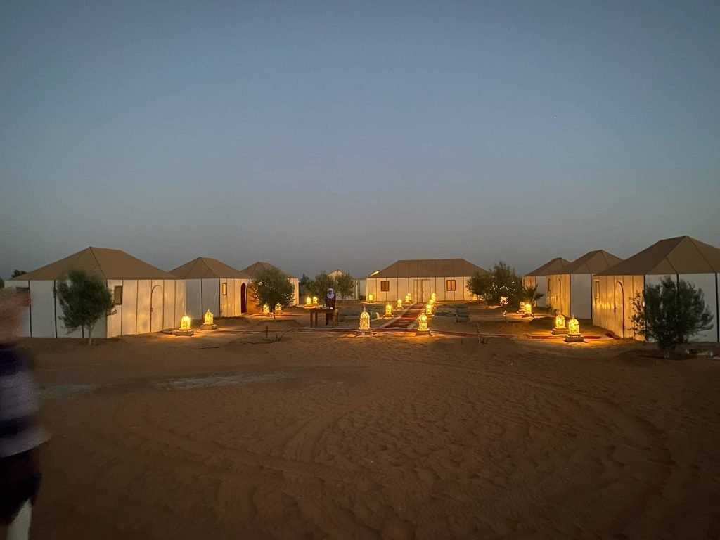camp in the desert lit up by little lights