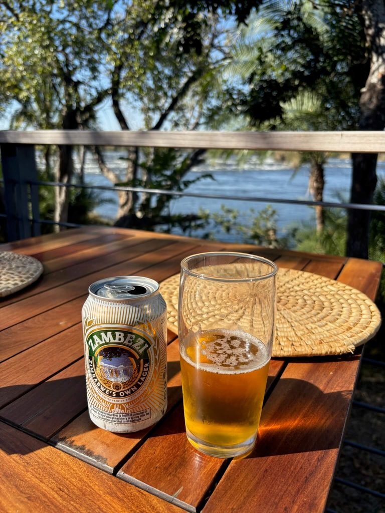 zambezi can of beer next to zambezi river