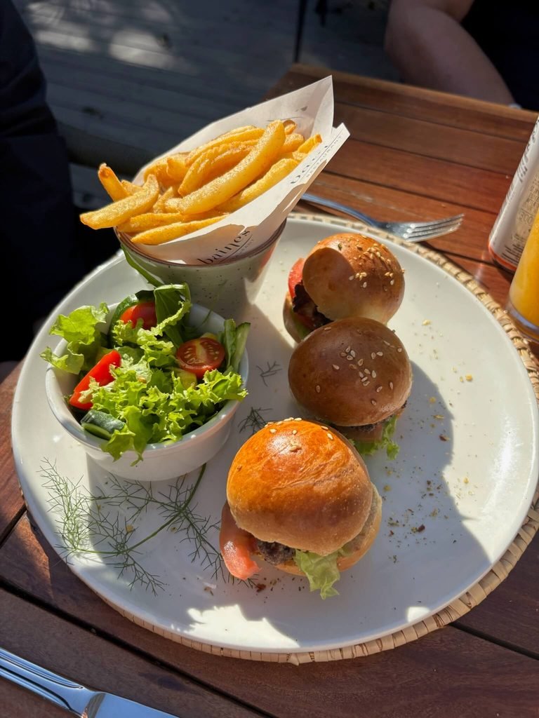 plate of chips, salad and three different types of burgers