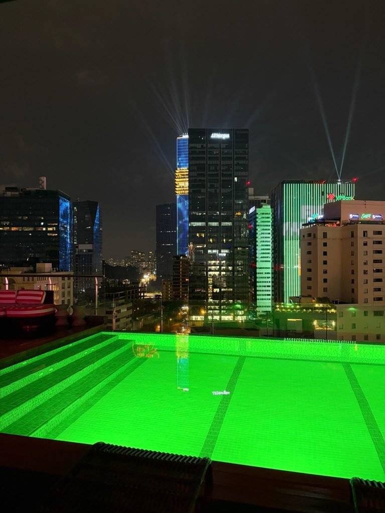 ho chi minh skyline at night over the swimming pool