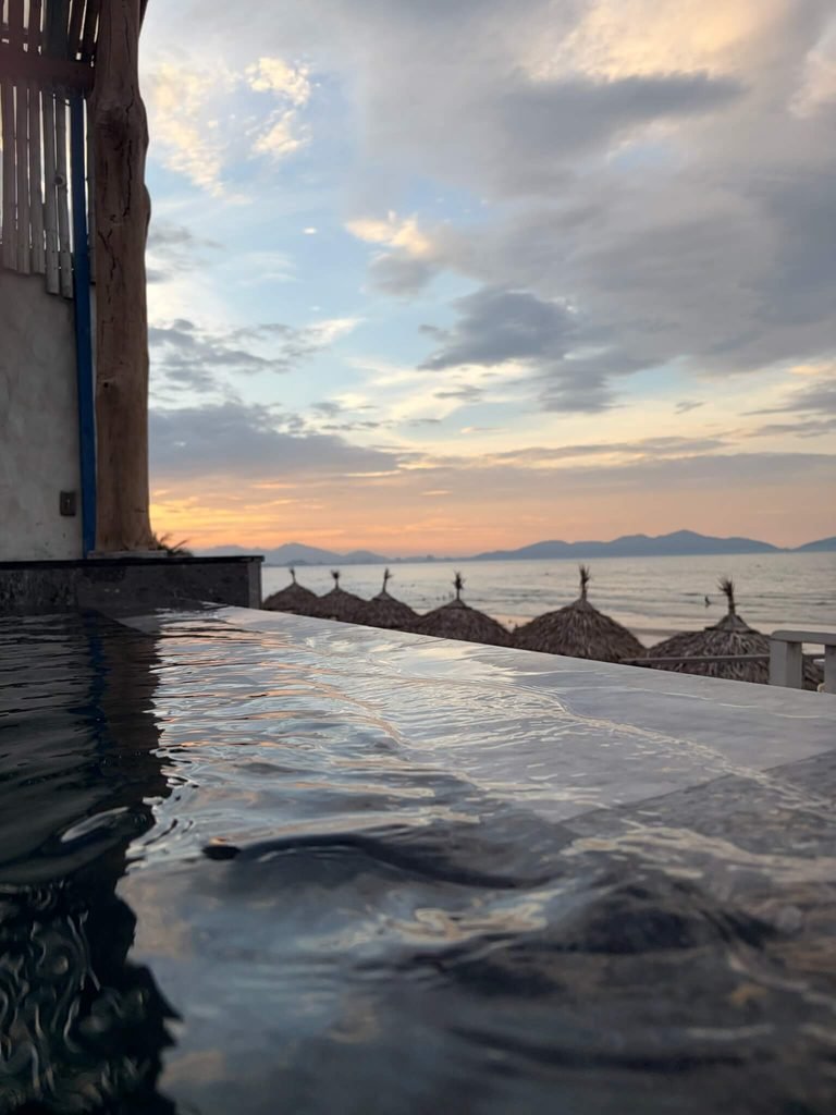 infinity pool onto beach at sunset