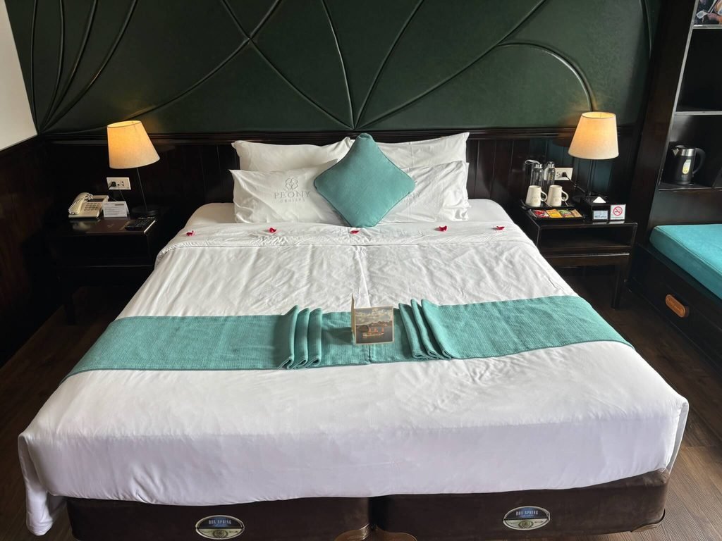 hotel bed with rose petals on